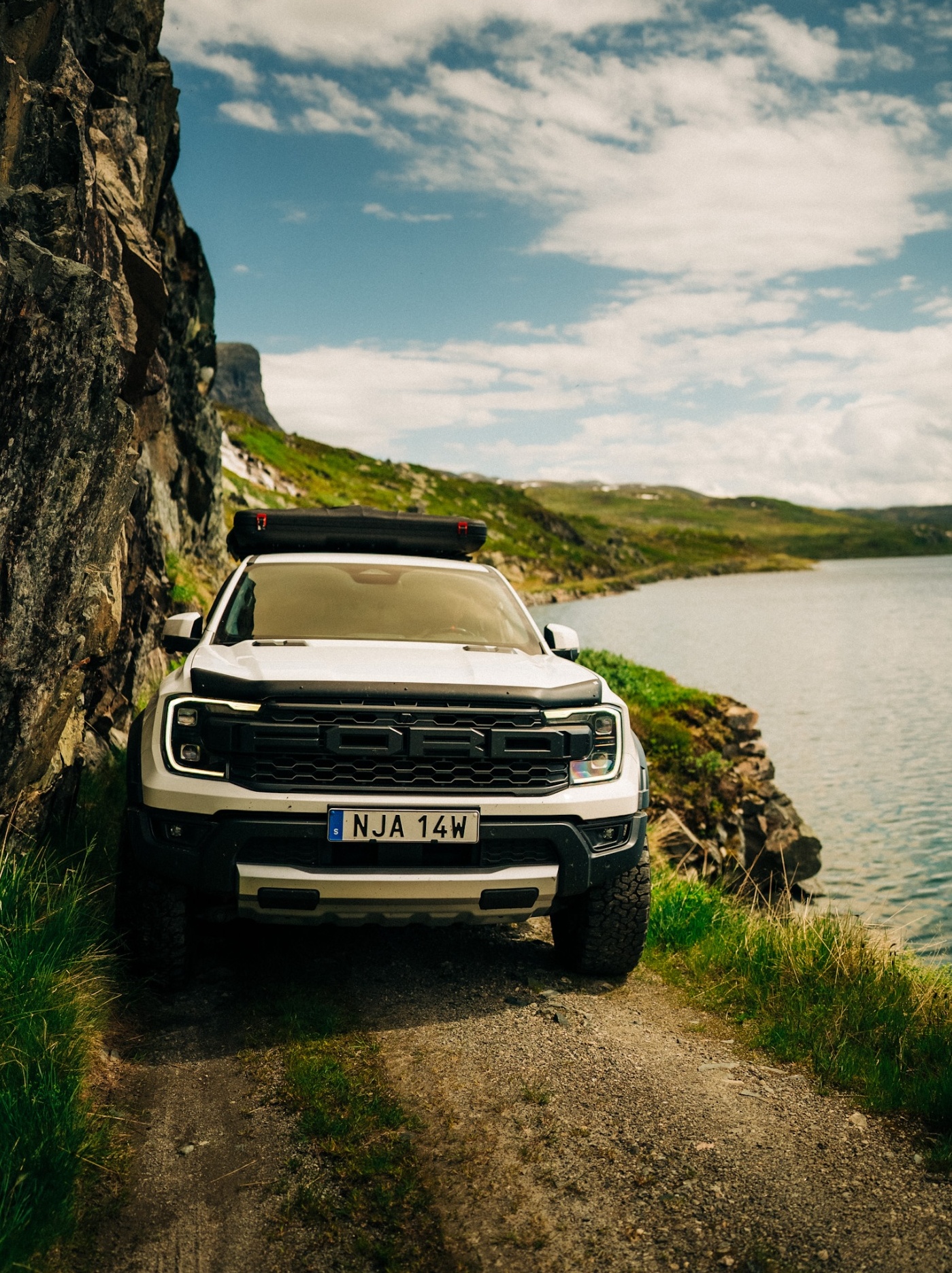 Ranger Raptor on a narrow lakeside trail in the Nordics